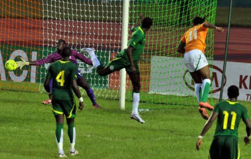 Ivory Coast's Didier Drogba (Top R) shoots against Senegal during the African Cup of Nations qualification match at the Felix Houphouet-Boigny stadium in Abidjan. Ivory Coast won 4-2