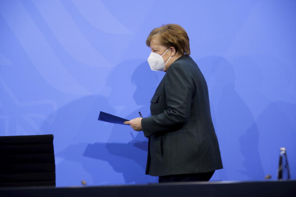 German Chancellor Angela Merkel arrives for a news conference on further coronavirus measures, at the Chancellery in Berlin, Germany, Tuesday Jan. 19, 2021. (Hannibal Hanschke/Pool via AP)