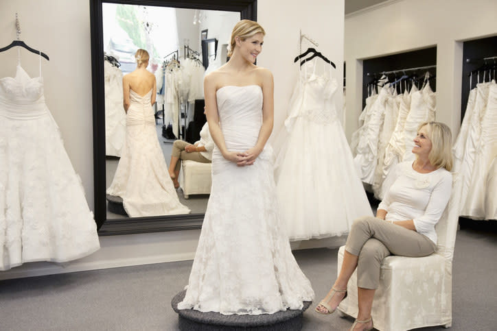 A woman trying on a wedding dress