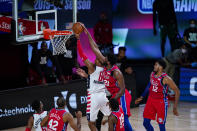 Philadelphia 76ers center Joel Embiid (21) comes from behind to block the shot of Washington Wizards forward Rui Hachimura (8) during the second half of an NBA basketball game Wednesday, Aug. 5, 2020 in Lake Buena Vista, Fla. (AP Photo/Ashley Landis)