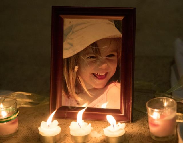 Candles next to a photo of Madeleine McCann inside the Church of Nossa Senhora da Luz in Praia da Luz (Steve Parsons/PA) (PA Archive)