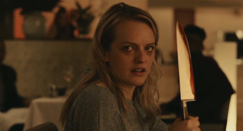 Elizabeth Moss holding a bloodied knife