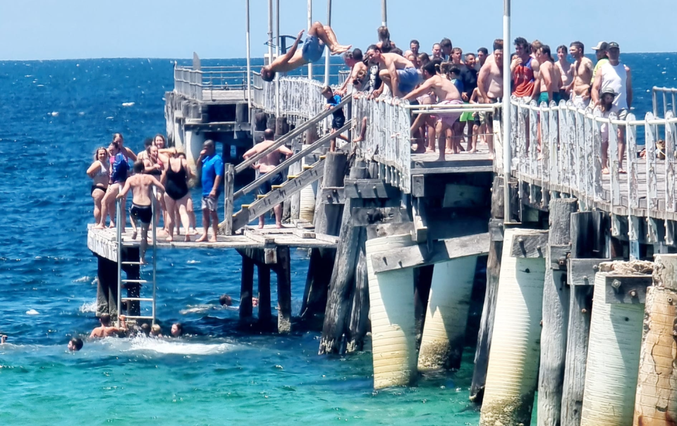 A big crowd seen jumping off the jetty at Tumby Bay