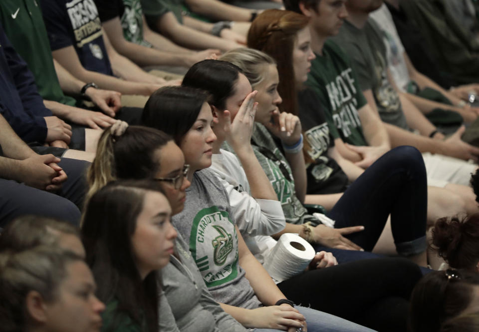 A student wipes her face during a vigil at the University of North Carolina-Charlotte in Charlotte, N.C., Wednesday, May 1, 2019 after a student with a pistol killed two people and wounded four others on Tuesday. (AP Photo/Chuck Burton)