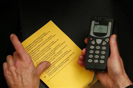 A member of The Church of England's General Synod prepares to vote at Church House in central London November 20, 2013. REUTERS/Andrew Winning