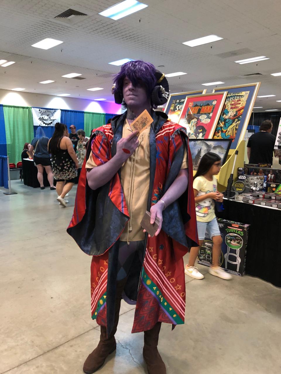Cy Darrow is portraying a Mollymauk Tealeaf from Critical Role at AMA-CON in Amarillo. His purple tint was beginning to run, one of the hazards of makeup.