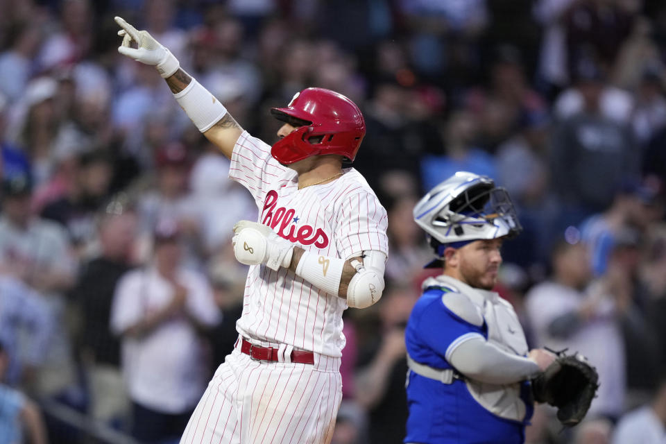 Philadelphia Phillies' Nick Castellanos, left, reacts after hitting a two-run home run against Toronto Blue Jays starting pitcher Alek Manoah during the fourth inning of a baseball game, Tuesday, May 9, 2023, in Philadelphia. (AP Photo/Matt Slocum)