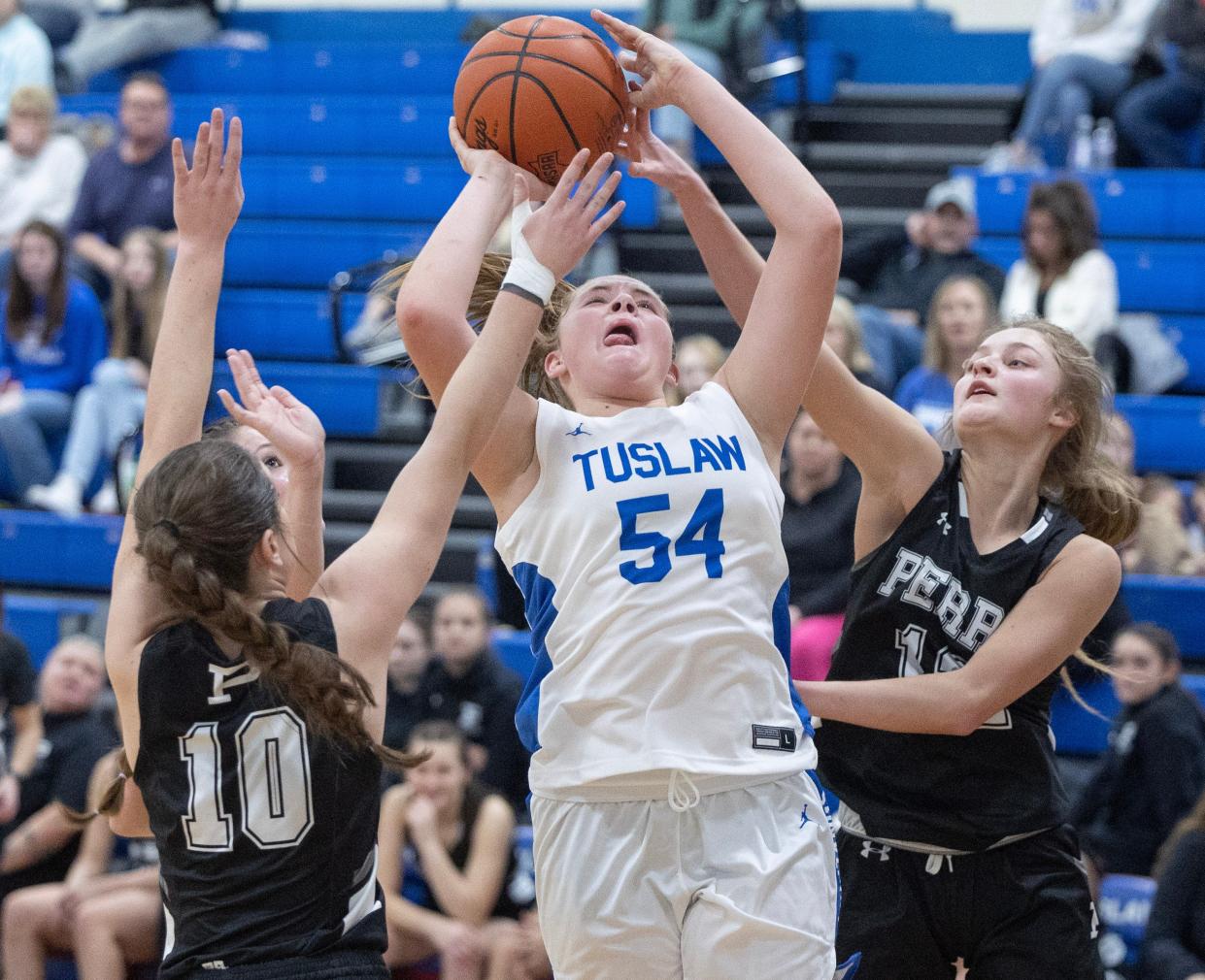 Tulsaw's Breanna McCabe draws the foul defended by Perry's Marlee Pieru (10) and Riley Minor (12) in the first half of Wednesday's game.