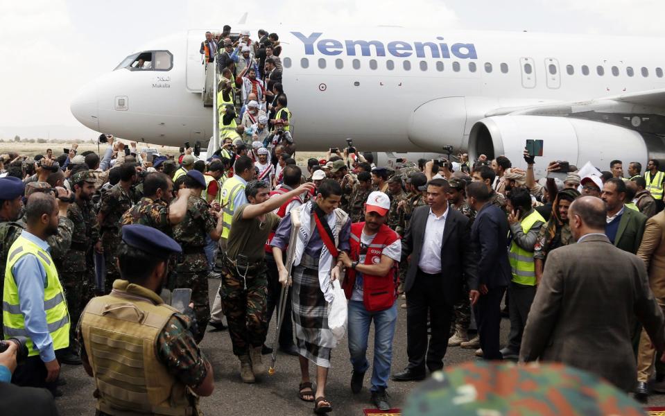 Freed Yemeni detainees disembark from a Red Cross plane in the capital Sanaa - GETTY IMAGES