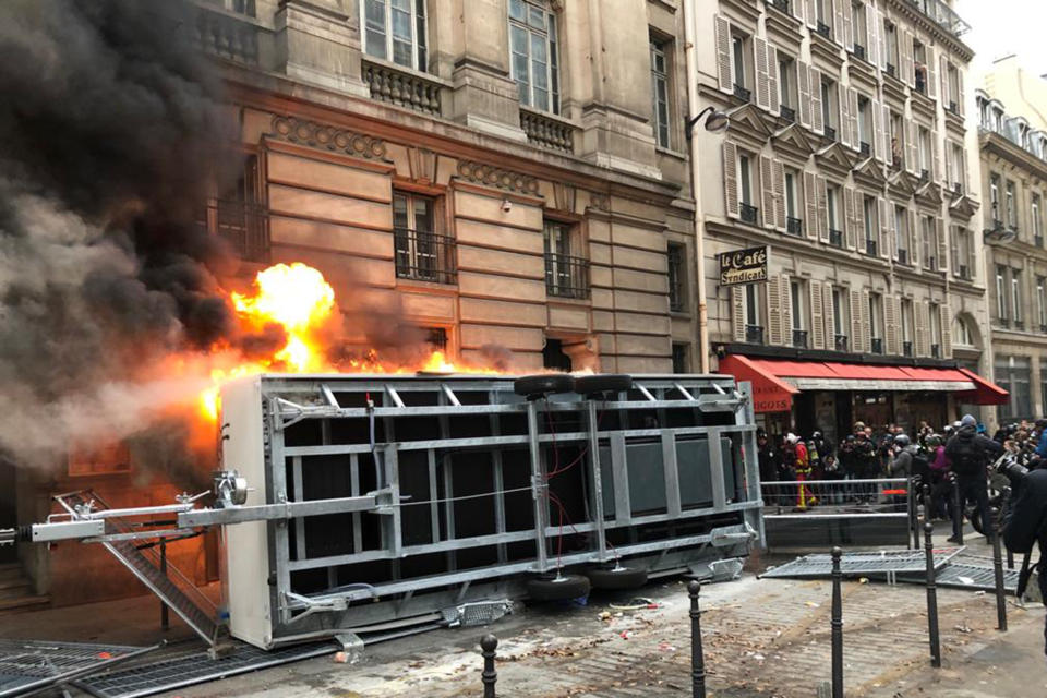 A truck is set ablaze during a demonstration in Paris, Thursday, Dec. 5, 2019. The Eiffel Tower shut down Thursday, France's vaunted high-speed trains stood still and teachers walked off the job as unions launched nationwide strikes and protests over the government's plan to overhaul the retirement system. (AP Photo/Alexander Turnbull)