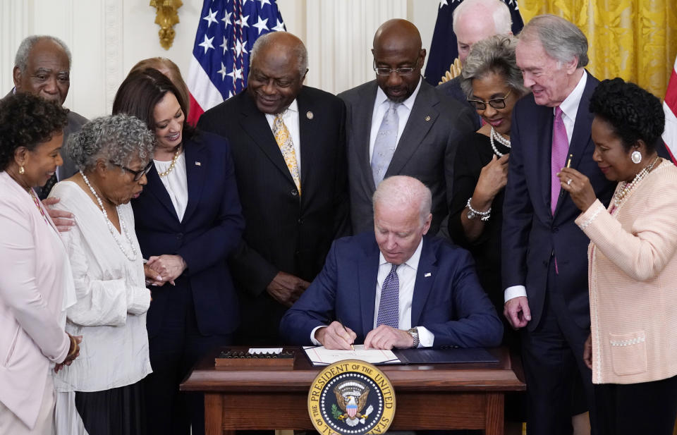 President Joe Biden signs the Juneteenth National Independence Day Act, in the East Room of the White House, Thursday, June 17, 2021, in Washington. From left, Rep. Barbara Lee, D-Calif, Rep. Danny Davis, D-Ill., Opal Lee, Sen. Tina Smith, D-Minn., obscured, Vice President Kamala Harris, House Majority Whip James Clyburn of S.C., Sen. Raphael Warnock, D-Ga., Sen. John Cornyn, R-Texas, Rep. Joyce Beatty, D-Ohio, Sen. Ed Markey, D-Mass., and Rep. Sheila Jackson Lee, D-Texas. (AP Photo/Evan Vucci)