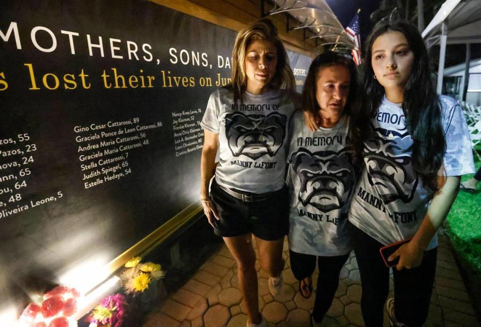 Adrianna LaFont, Ivonne Lafont Villagra, and Mia LaFont, left to right, visit a temporary memorial wall at Veterans Park across from the site of the Champlain Towers South collapse in Surfside on June 24, 2023. The three attended the Second Annual Remembrance Ceremony on the two-year anniversary of the collapse that killed their relative, Manny LaFont.