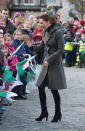 <p>For a day in Wales, Kate covered up in an olive green coat by Reiss and knee-length black boots by Italian brand, Aquatalia.</p><p><i>[Photo: PA]</i></p>