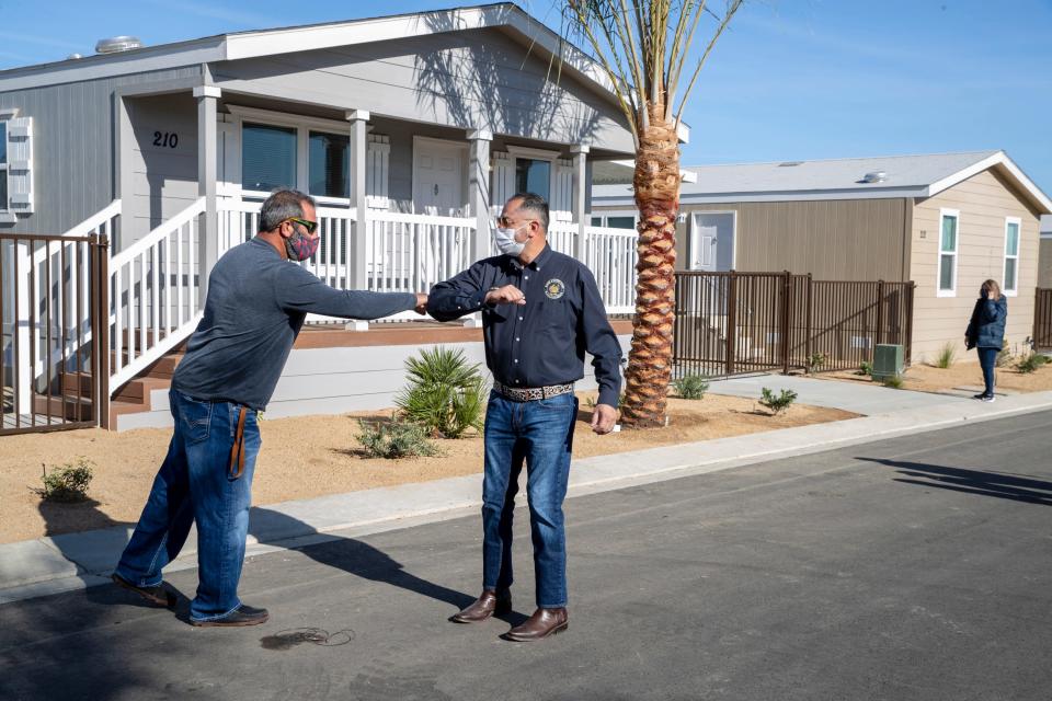 Riverside County Supervisor V. Manuel Perez, right, and Mountain View Estates owner Bobby Melkesian greet one another prior to speaking to residents of new mobile homes at Mountain View Estates in Oasis on Jan. 9, 2021.