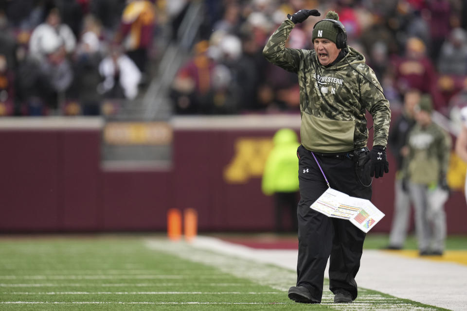 Northwestern head coach Pat Fitzgerald reacts after a pass interference penalty on Northwestern defensive back Devin Turner (23) during the first half of an NCAA college football game against Minnesota, Saturday, Nov. 12, 2022, in Minneapolis. (AP Photo/Abbie Parr)