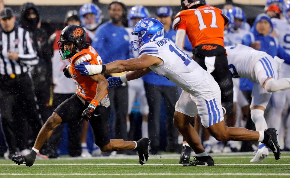 Oklahoma State's Brennan Presley (80) tries to get by BYU's AJ Vongphachanh (10) in the second half of the college football game between the Oklahoma State University Cowboys and the Brigham Young Cougars at Boone Pickens Stadium in Stillwater, Okla., Saturday, Nov. 25, 2023.