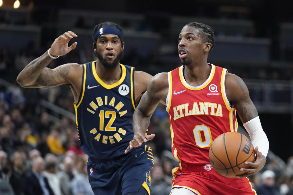 Atlanta Hawks' Delon Wright (0) goes to the basket against Indiana Pacers' Oshae Brissett (12) during the first half of an NBA basketball game Wednesday, Dec. 1, 2021, in Indianapolis. (AP Photo/Darron Cummings)