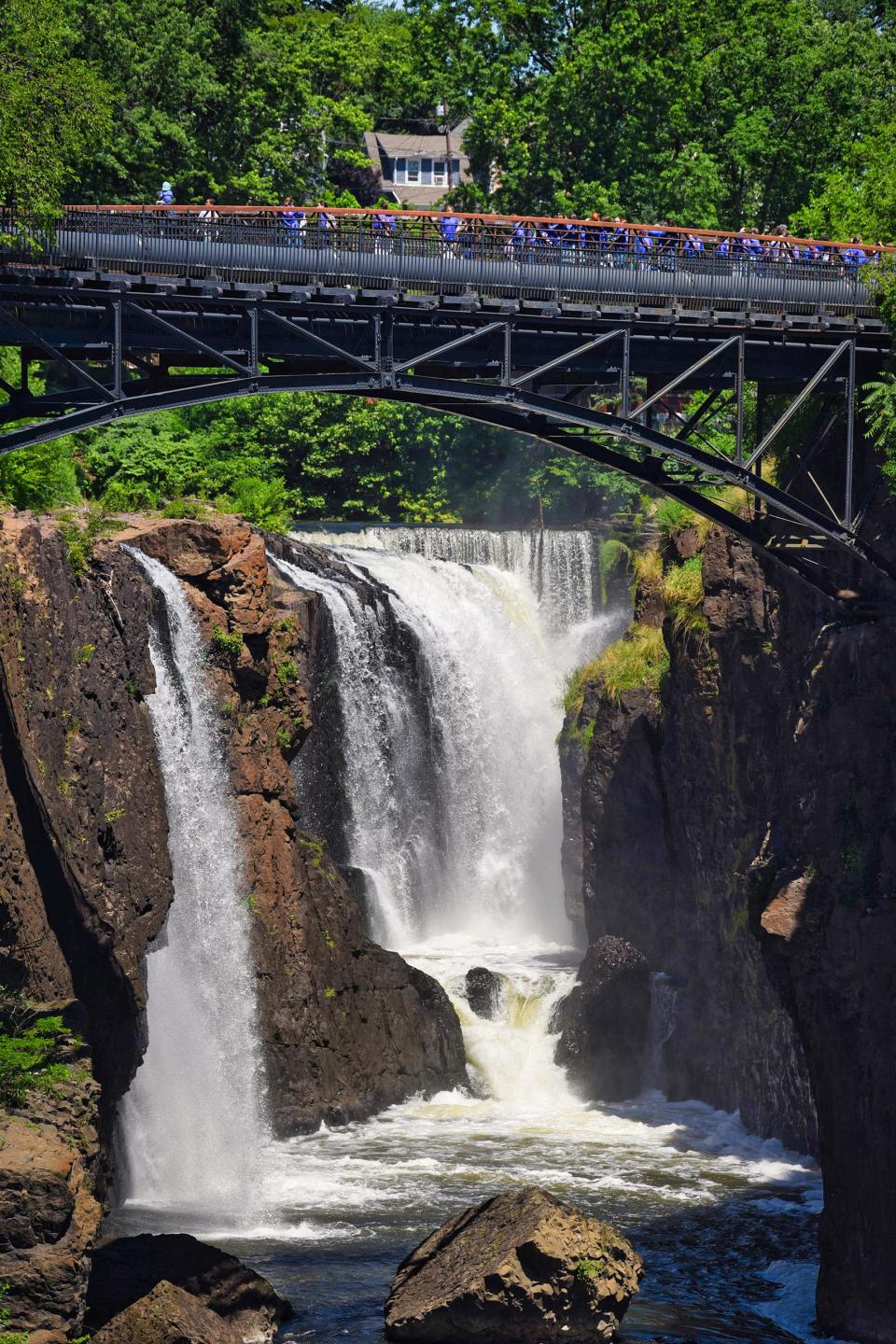 Visitors observe the Paterson Great Falls National Historical Park on June 23, 2021.