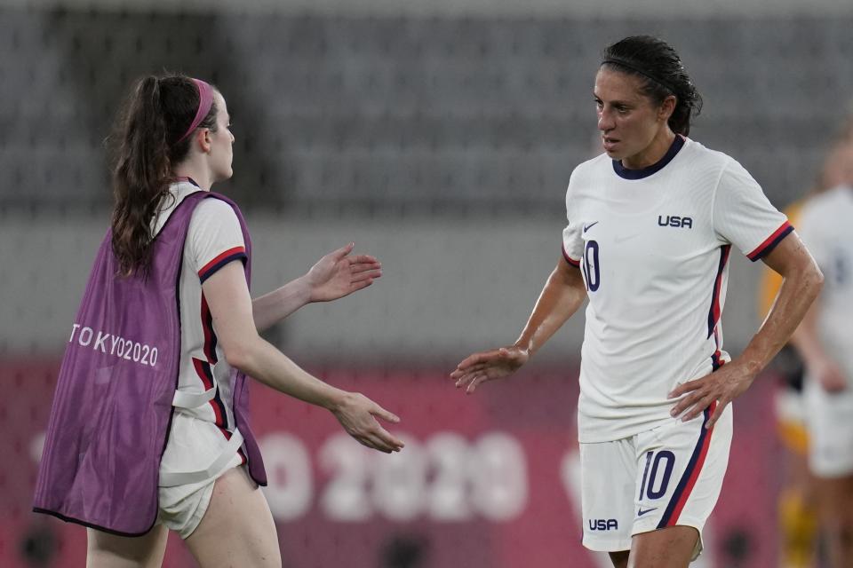 United States' Carli Lloyd, right, leaves the field after losing 0-3 against Sweden during a women's soccer match against Sweden at the 2020 Summer Olympics, Wednesday, July 21, 2021, in Tokyo. (AP Photo/Ricardo Mazalan)