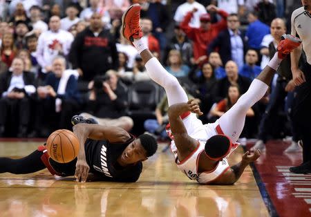 May 3, 2016; Toronto, Ontario, CAN; Miami Heat guard Josh Richardson (0) chases a loose ball with Toronto Raptors guard Terrence Ross (32) in game one of the second round of the NBA Playoffs at Air Canada Centre. Mandatory Credit: Dan Hamilton-USA TODAY Sports