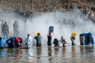 <p>Police use pepper spray against people standing in the water of a river during a protest against the building of a pipeline on the Standing Rock Indian Reservation near Cannonball, N.D., on Nov. 2, 2016. (Photo: Stephanie Keith/Reuters) </p>