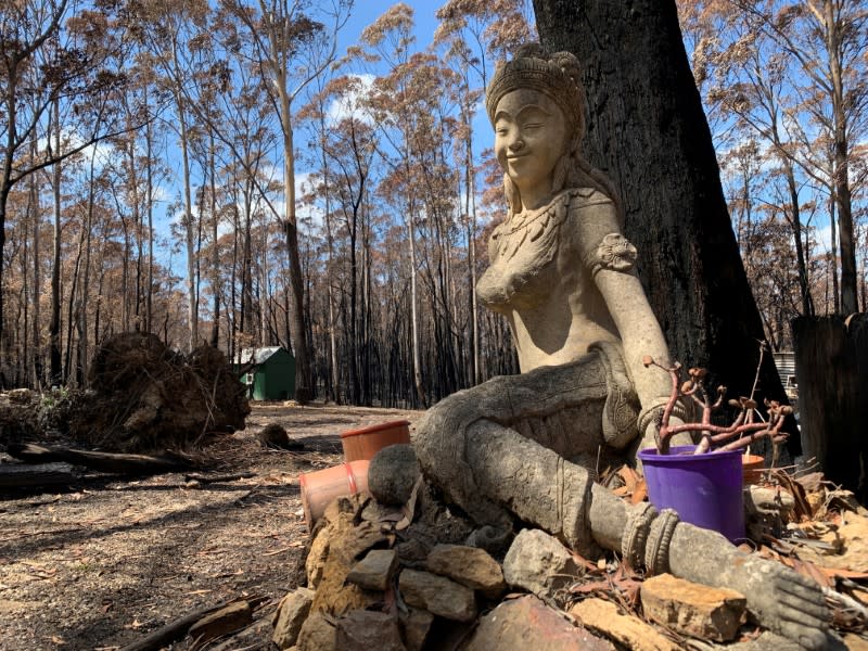 A Buddhist statue is seen at the burnt area of Sunnataram Forest Monastery in Bundanoon, Australia