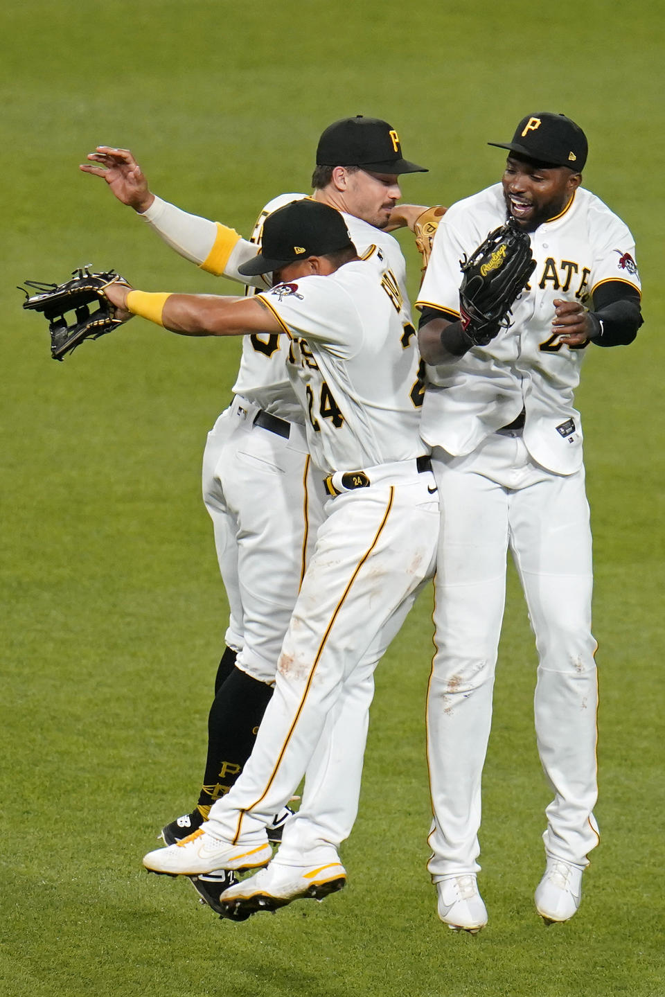 Pittsburgh Pirates outfielders Phillip Evans (24), Bryan Reynolds, center rear, and Gregory Polanco, right, celebrate after getting the final out of a baseball game against the Chicago White Sox in Pittsburgh, Tuesday, June 22, 2021. The Pirates won 6-3. (AP Photo/Gene J. Puskar)