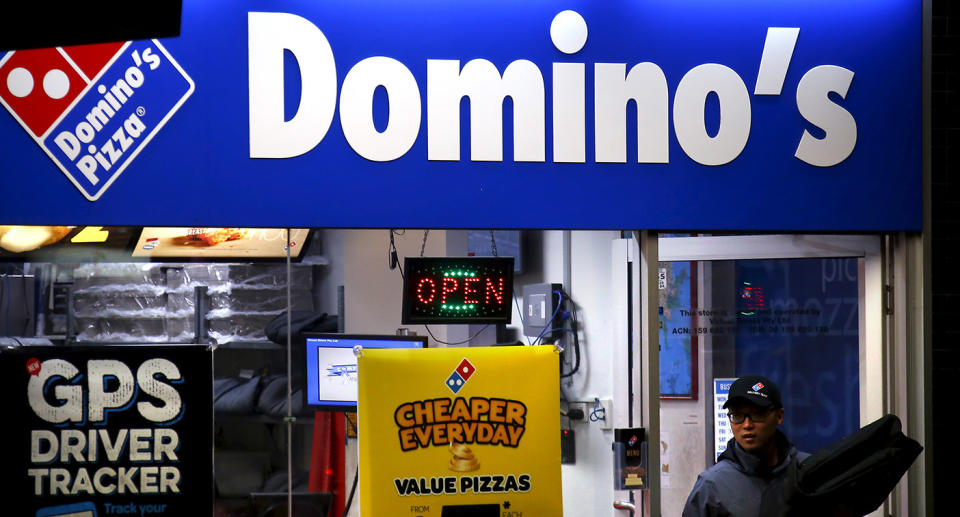 Worker exiting Domino's Pizza store