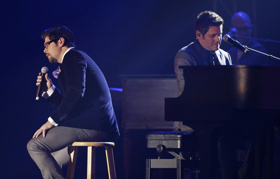 Jason Crabb, left, and Jay DeMarcus, of the group Rascal Flatts, perform at the Dove Awards on Tuesday, Oct. 15, 2013, in Nashville, Tenn. (AP Photo/Mark Humphrey)