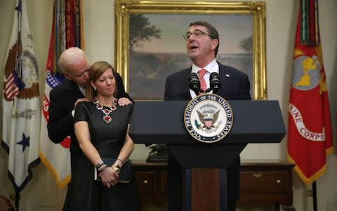 Former Defence Secretary Ashton Carter makes remarks as his wife Stephanie listens with Joe Biden - Credit: Getty