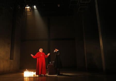 Actors Paul Jesson (L, as Cardinal Wolsey) and Ben Miles (as Thomas Cromwell) perform in an adaptation of Hilary Mantel's books "Wolf Hall" and "Bring Up the Bodies" during a photocall at the Aldwych Theatre in London May 15, 2014. REUTERS/Luke MacGregor