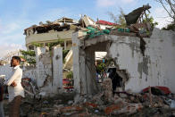 <p>A man stands outside the scene of an attack on a hotel and an adjacent restaurant in Mogadishu, Somalia, June 15, 2017. (Photo: Stringer/Reuters) </p>