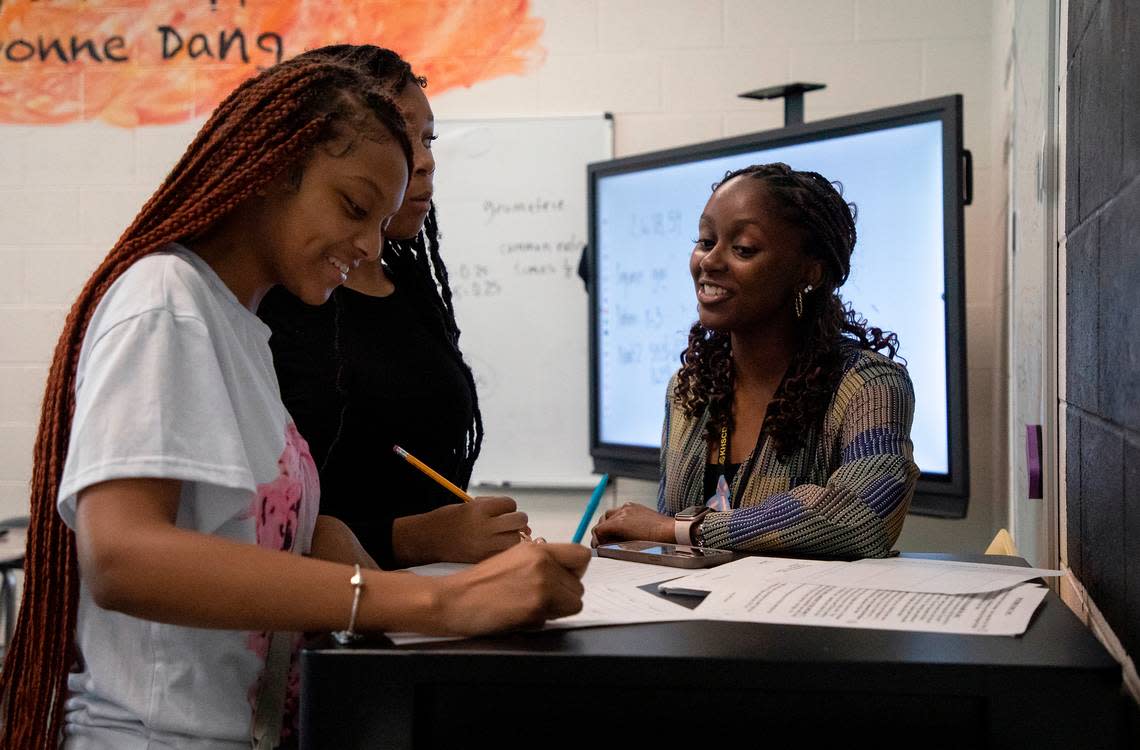 Knightdale High School teacher Alex Johnson works with Anisha Tann and Amya Reade during a math class on Tuesday, Sept. 5, 2023, in Knightdale, N.C. Kaitlin McKeown/kmckeown@newsobserver.com