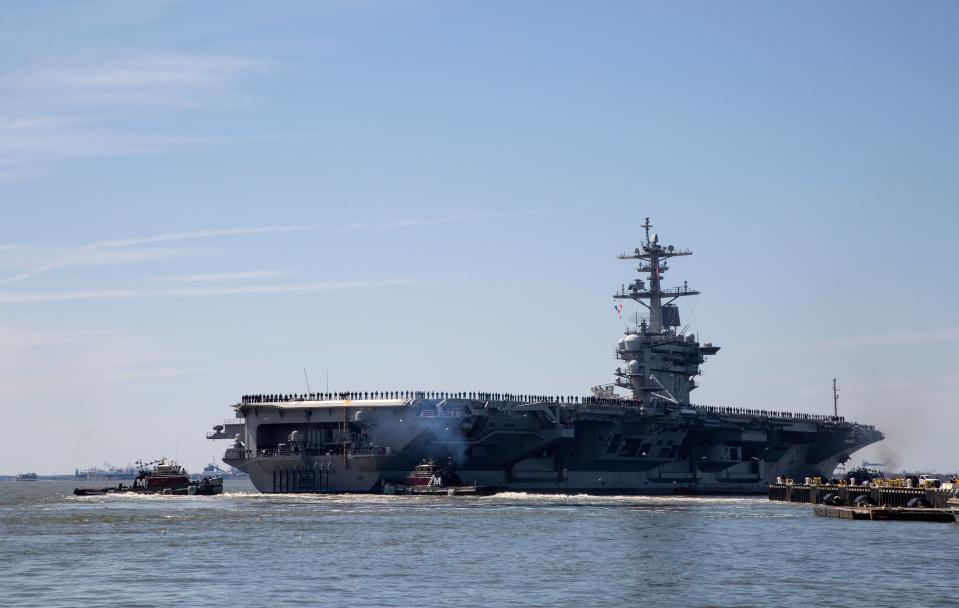 In this April 1, 2019, file photo, the USS Abraham Lincoln deploys from Naval Station Norfolk, in the vicinity of Norfolk, Va. The White House said Sunday, May 5, that the U.S. is deploying military resources to send a message to Iran. White House national security adviser John Bolton said in a statement that the U.S. is deploying the USS Abraham Lincoln Carrier Strike Group and a bomber task force to the U.S. Central Command region, an area that includes the Middle East. (Kaitlin McKeown/The Virginian-Pilot via AP, File)