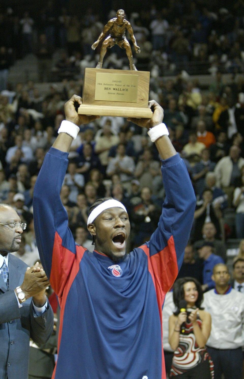 Ben Wallace holds up his NBA Defensive Player of the Year trophy prior to Game 2 of the playoff series vs. Orlando at the Palace, April 23, 2003.