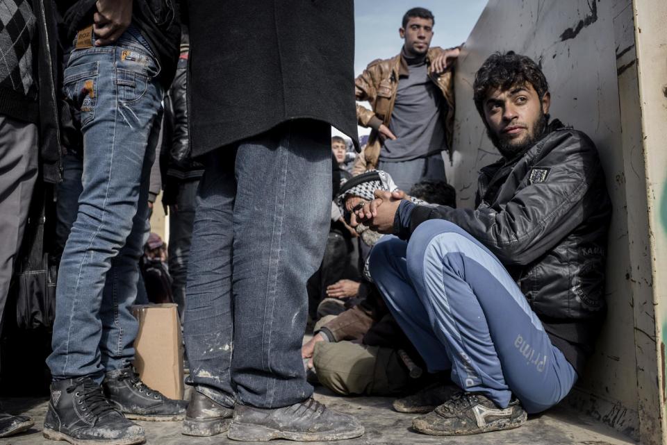 Iraqis displaced from Mosul wait aboard trucks for transportation to IDP camps, in near Bartella, Iraq on Thursday, Dec. 29, 2016. Breaking a two-week lull in fighting, Iraqi troops backed by the U.S.-led coalition's airstrikes and artillery pushed deeper into eastern Mosul on Thursday in a multi-pronged assault against Islamic State militants in the city. (AP Photo/Cengiz Yar)