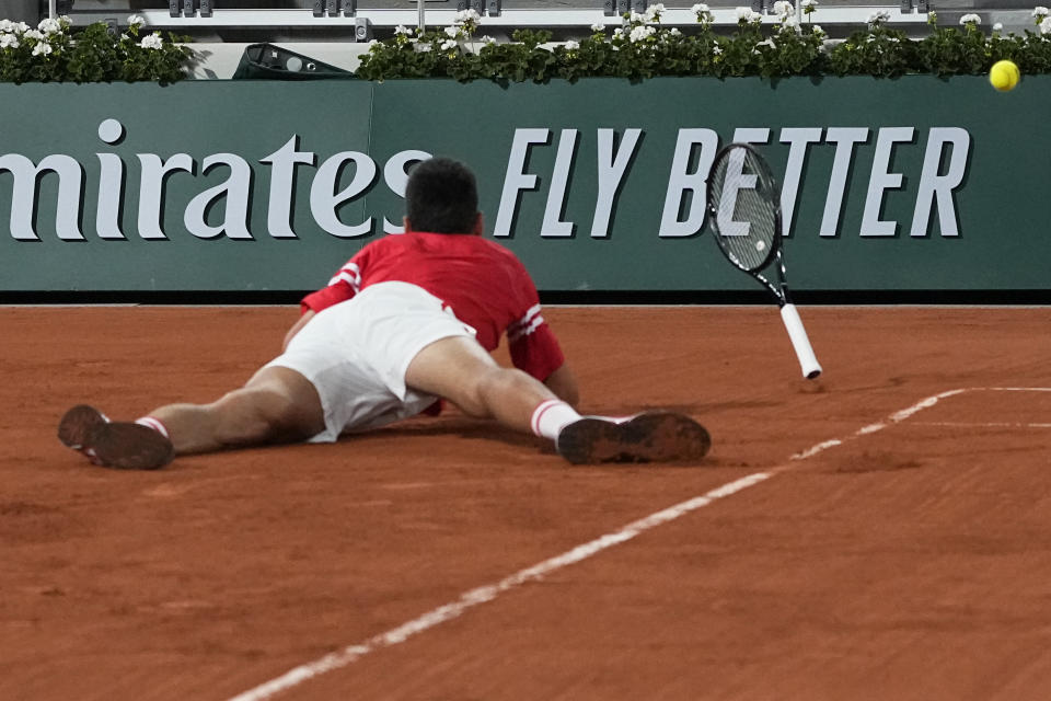 Serbia's Novak Djokovic falls as he plays Italy's Matteo Berrettini in a quarterfinal match of the French Open tennis tournament at the Roland Garros stadium Wednesday, June 9, 2021 in Paris. (AP Photo/Michel Euler)