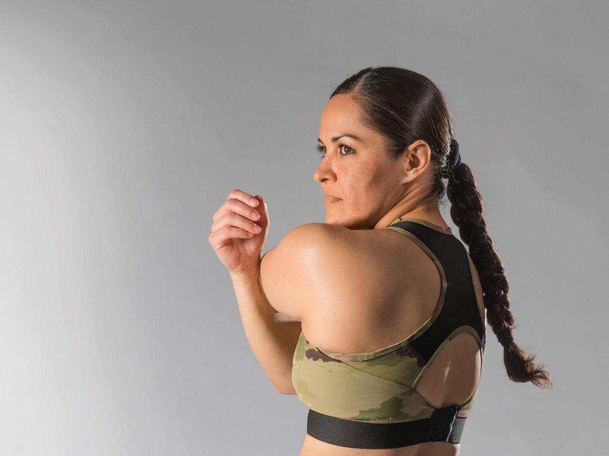 A soldier wears a sports bra that served as an early mock-up sample for conceptualization of the Army Tactical Brassiere.