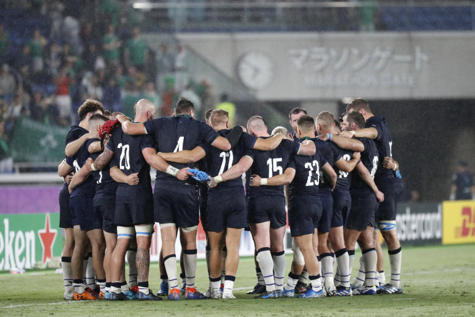 Scotland's player gather after the Rugby World Cup Pool A game at International Stadium between Ireland and Scotland in Yokohama, Japan, Sunday, Sept. 22, 2019. (AP Photo/Eugene Hoshiko)