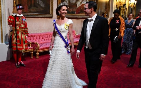 The Duchess of Cambridge (L) walks with US Secretary of Treasury Steven Mnuchin - Credit: Victoria Jones / POOL / AFP