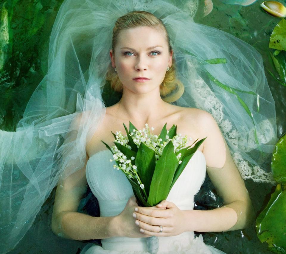 Dunst looking sad in a stunning wedding gown in the movie melancholia