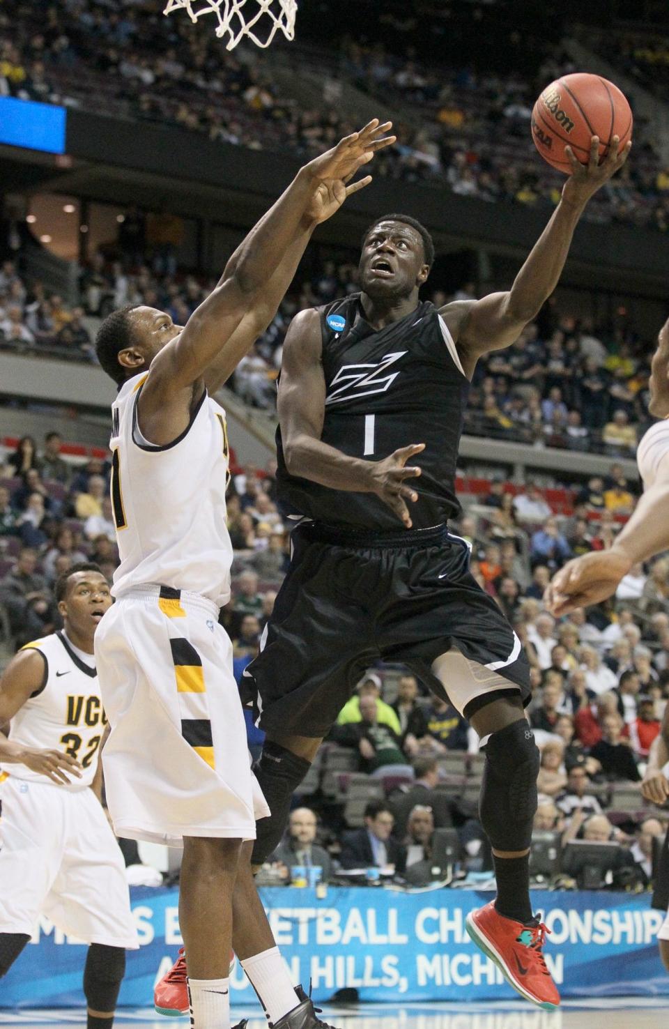 Akron's Demetrius Treadwell (right) drives past VCU's Treveon Graham in an NCAA Tournament game at The Palace on March 21, 2013.