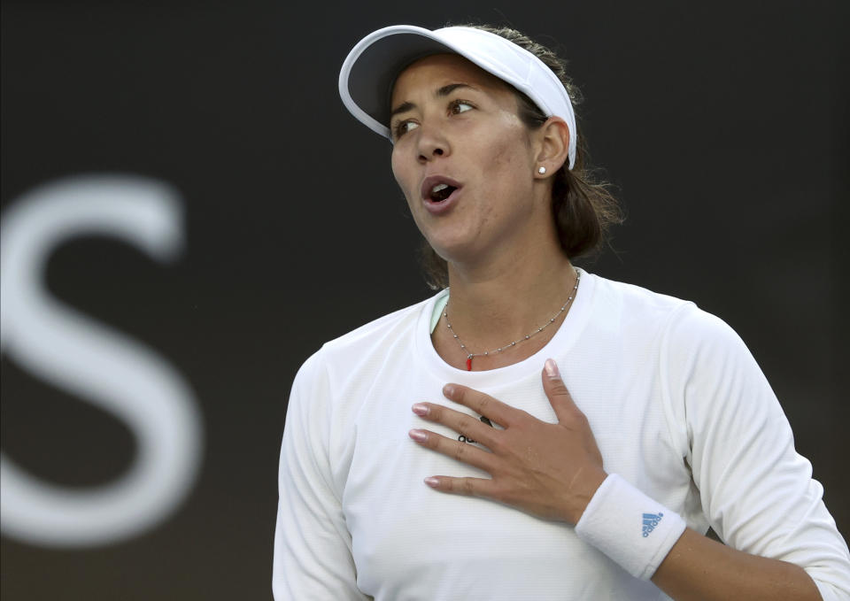 Spain's Garbine Muguruza celebrates after defeating Shelby Rogers of the U.S. in their first round singles match at the Australian Open tennis championship in Melbourne, Australia, Tuesday, Jan. 21, 2020. (AP Photo/Lee Jin-man)