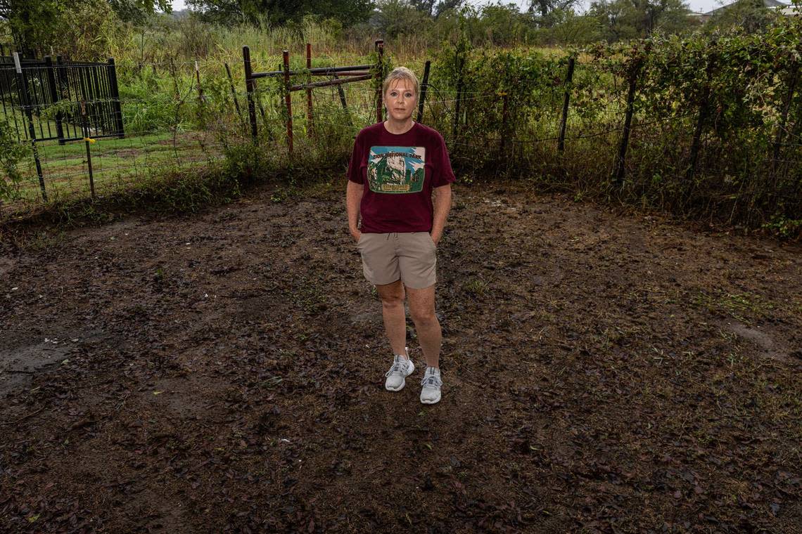 Springtown resident Cynthia Courtney is photographed in her backyard where she used to have grass and grass seed, but has since turned into a field of mud and dirt. Courtney has dealt with flooding issues since the D.R. Horton subdivision was built behind her property in 2023. According to Courtney, the construction has disrupted the natural drainage pattern and has since caused substantial flooding in and around her home.