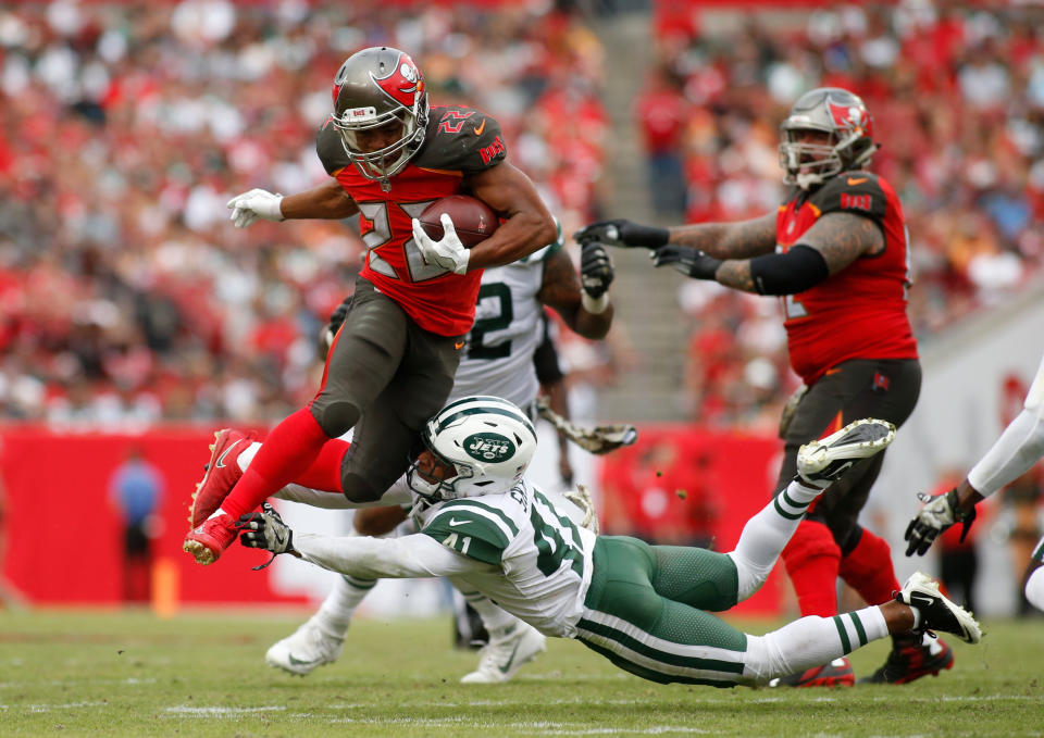 <p>Running back Doug Martin #22 of the Tampa Bay Buccaneers leaps over an tackle attempt by cornerback Buster Skrine #41 of the New York Jets as he runs for a first down during the fourth quarter of an NFL football game on November 12, 2017 at Raymond James Stadium in Tampa, Florida. (Photo by Brian Blanco/Getty Images) </p>