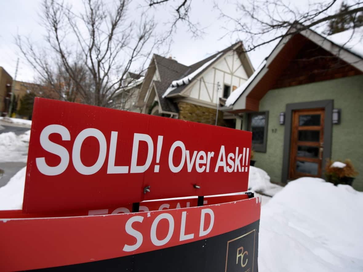 A sign outside an Ottawa home indicates that it has sold for over the asking price in March 2021. Ottawa has seen the largest jump in real estate investor activity in recent years of any major Canadian city. Halifax is not far behind, in second place. (Justin Tang/Canadian Press - image credit)