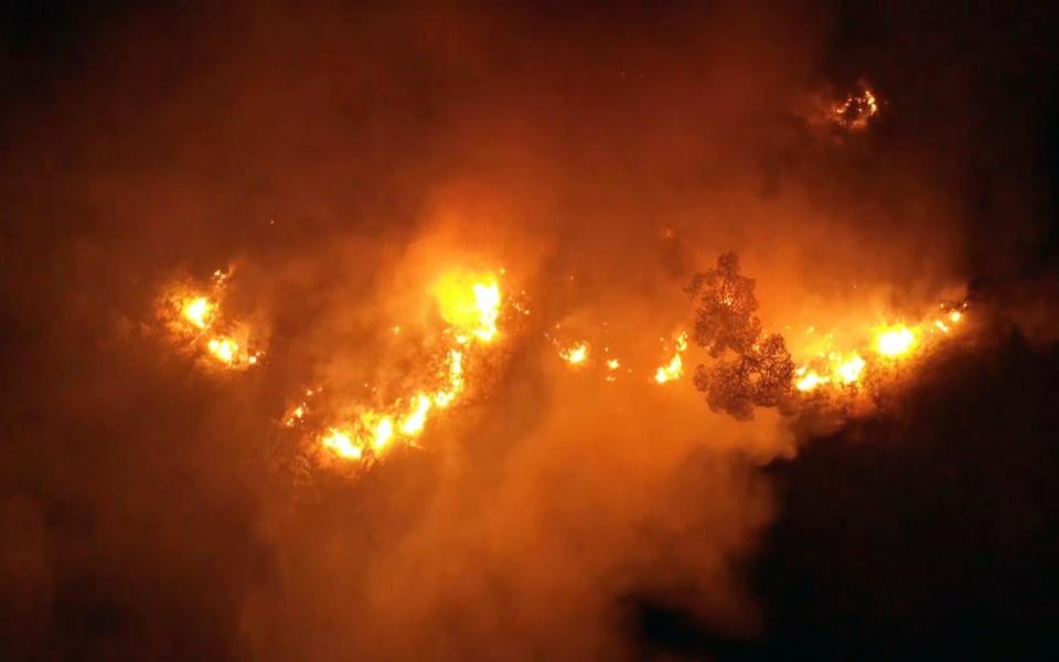 Flames rise at the scene of forest fire in Ras el-Harf village, in the Baabda district, Lebanon - -/AP