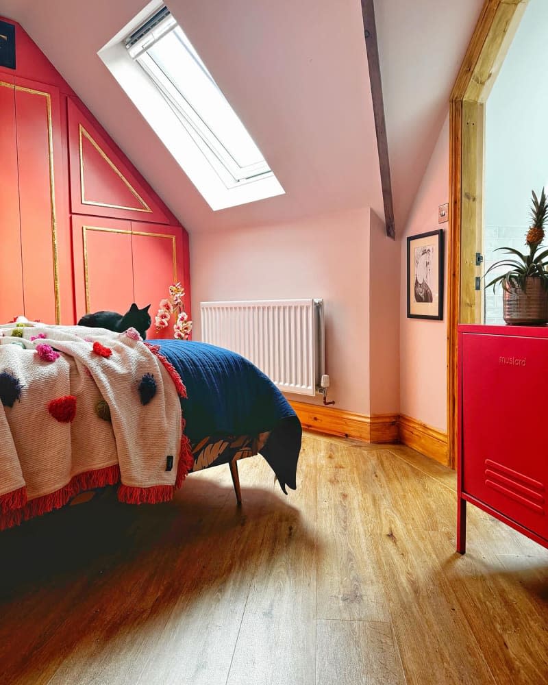 Pink painted walls in colorful bedroom.