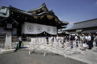 Worshippers queue to pay respects to the war dead at Yasukuni Shrine Saturday, Aug. 15, 2020, in Tokyo. Japan marked the 75th anniversary of the end of World War II. (AP Photo/Eugene Hoshiko)