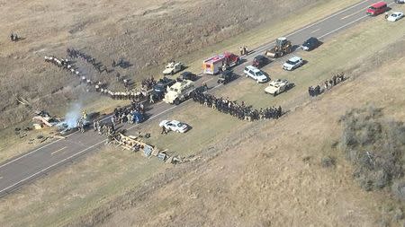 Protestors against the Dakota Access Pipeline stand-off with police in this aerial photo of Highway 1806 and County Road 134 near the town of Cannon Ball, North Dakota, U.S., October 27, 2016. Morton County Sheriff's Office/Handout via Reuters